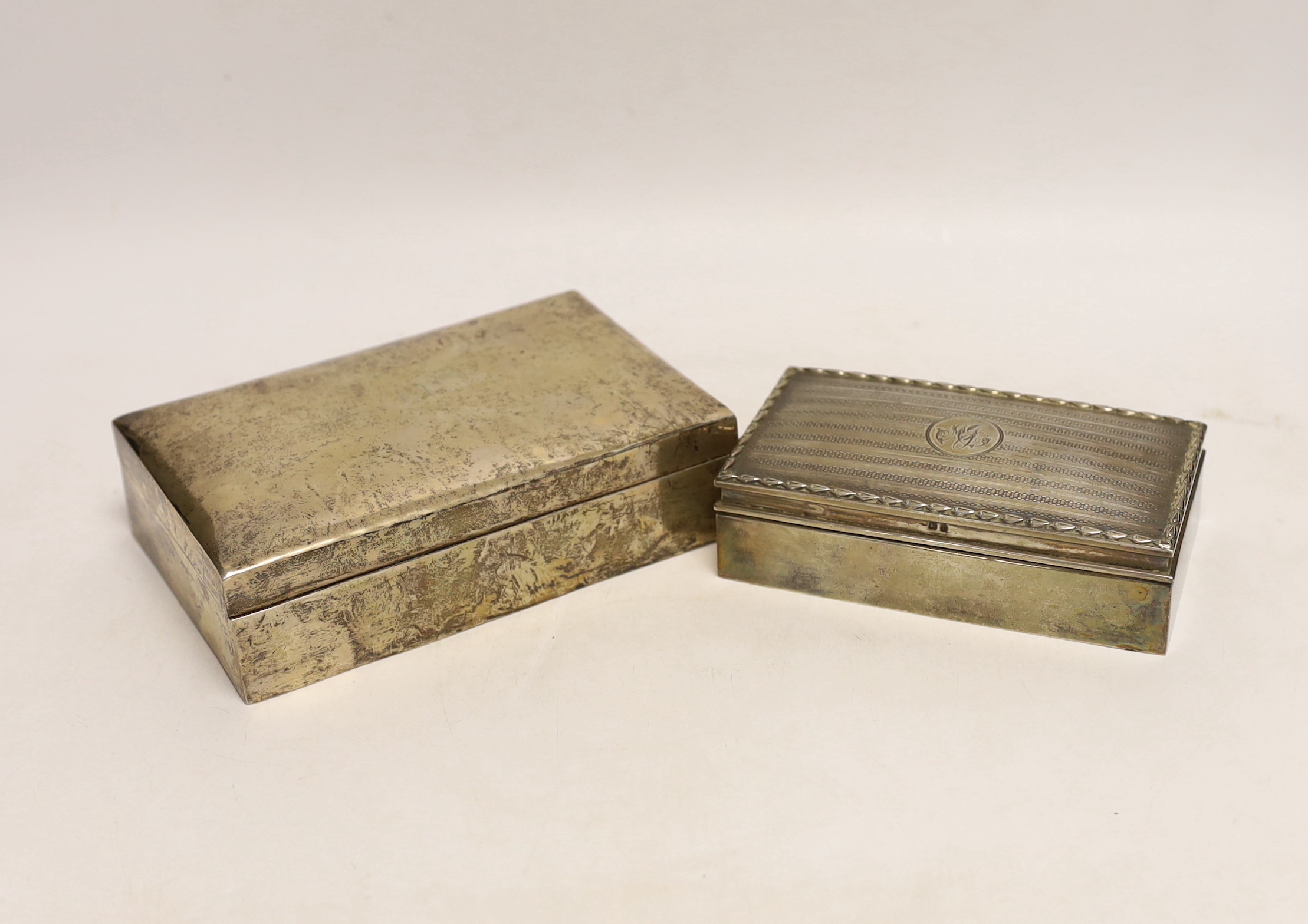 An Edwardian silver mounted rectangular cigarette box, by Synyer & Beddoes, Birmingham, 1908, 14cm, together with a larger Persian white metal mounted cigarette box.